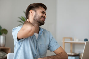 Man touching his painful stiff neck
