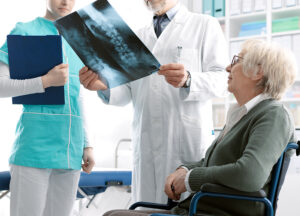 Spine surgeon reviewing female patient's X-ray